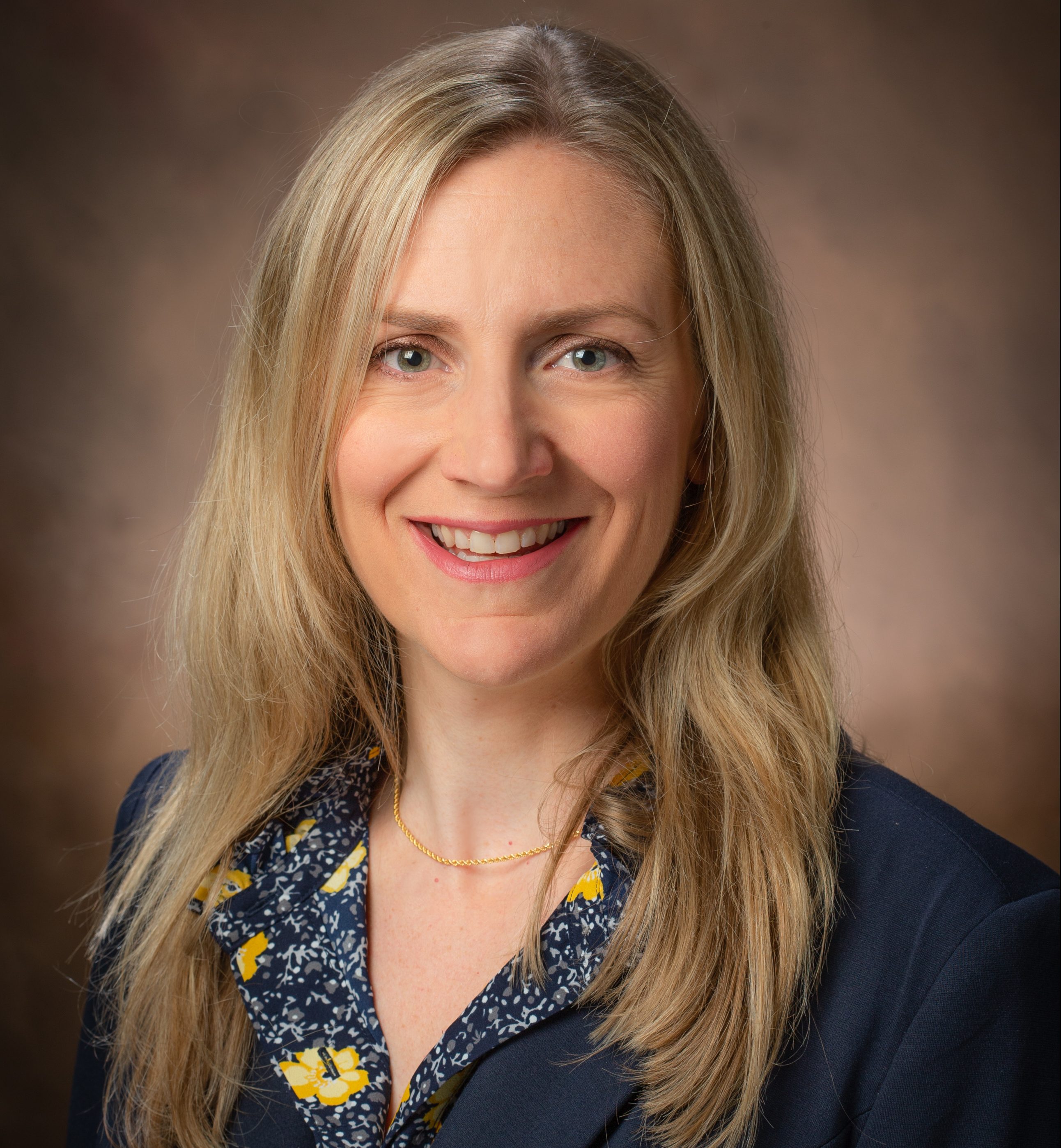 head shot of blonde woman in blue suit